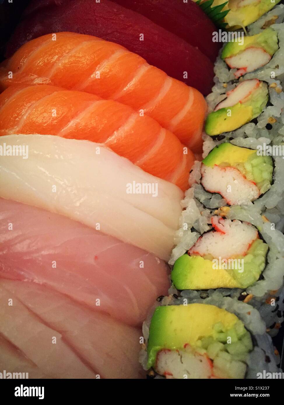 Fresh pieces of sushi and California roll from takeout Japanese restaurant, USA - Smartphone Captured Stock Image