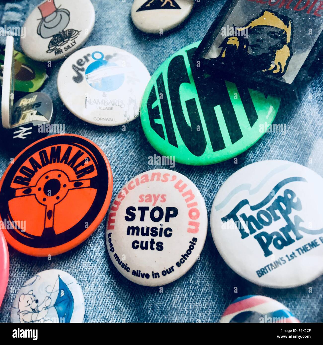 Eightie’s badges pinned to a denim jacket. Stock Photo