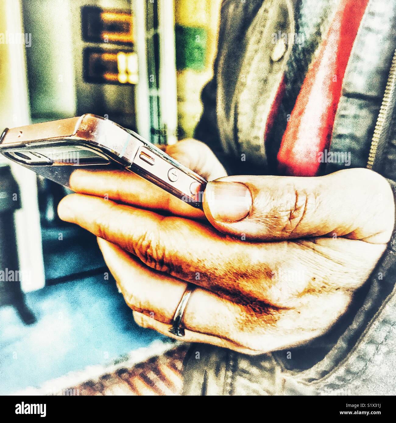 Woman using smartphone, indoors, close-up, midsection - Smartphone Captured Stock Image