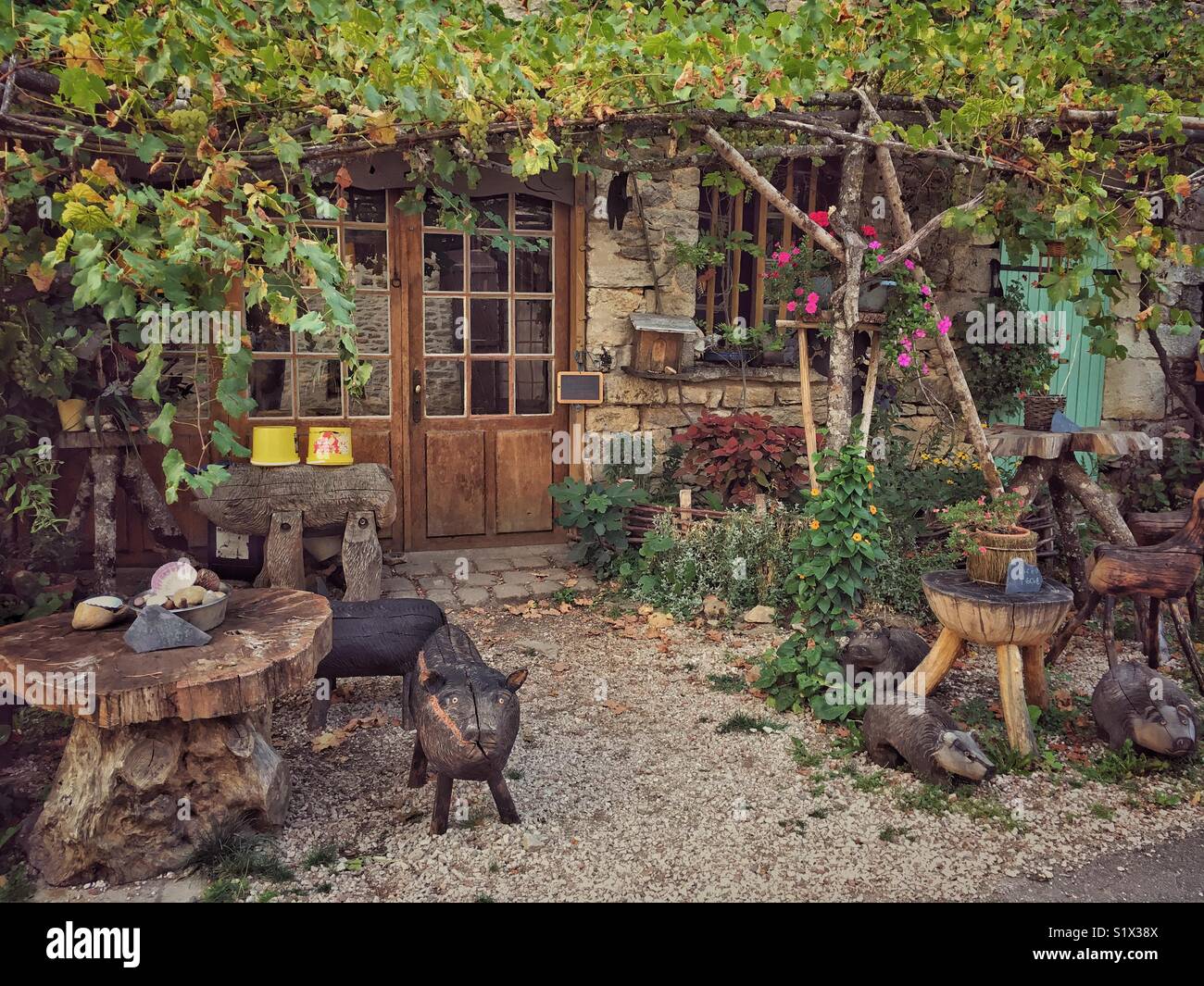 Wooden sculptures displayed at Artist’s workshop, Medieval Village of Châteauneuf en Auxois, Côte d’Or, Bourgogne Franche Comté, France - Smartphone Captured Stock Image