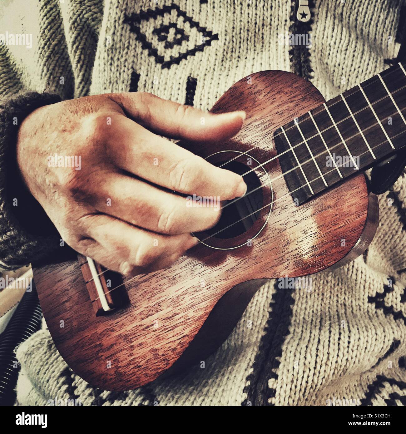Woman playing a soprano ukulele, close up - Smartphone Captured Stock Image