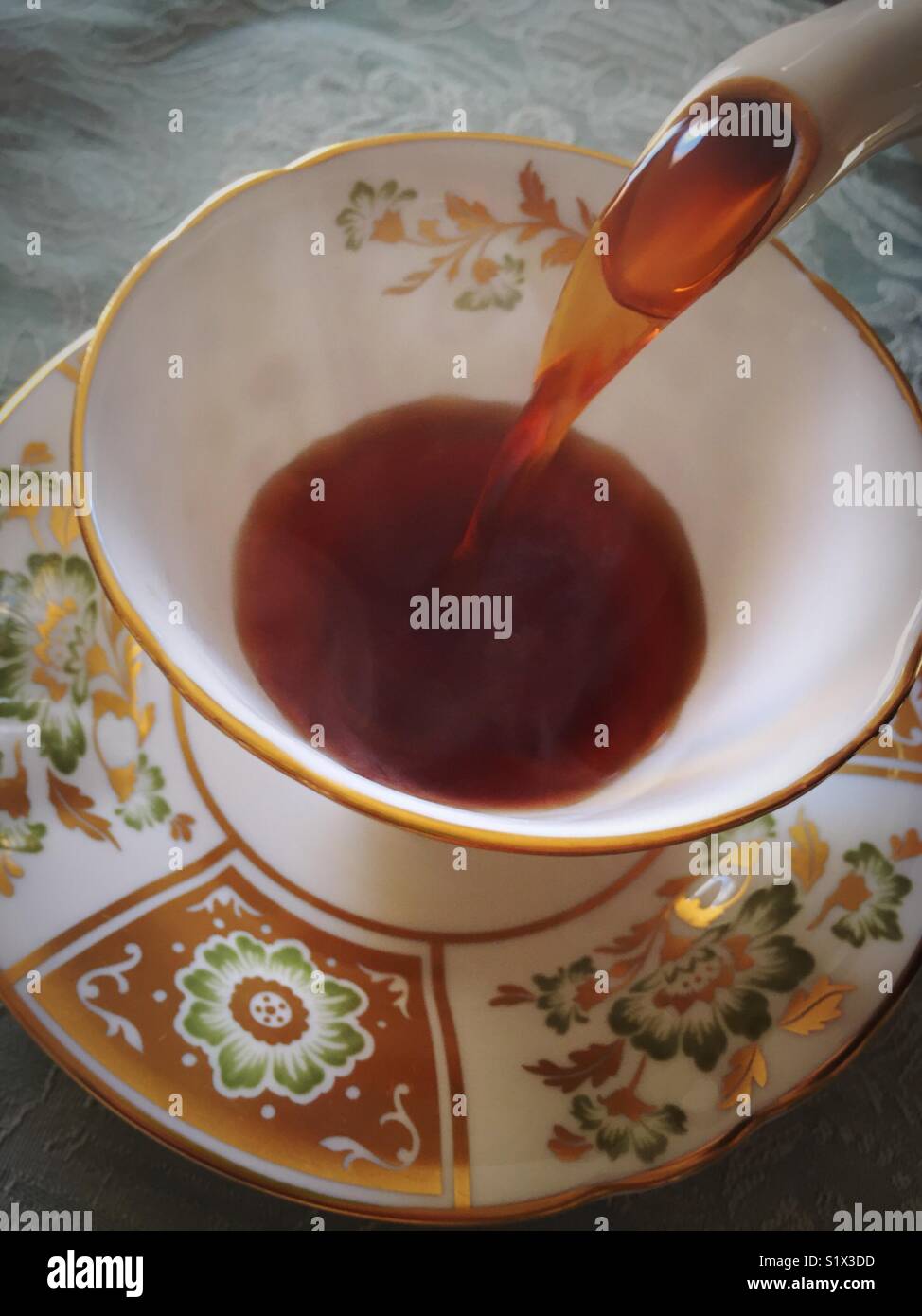 Pouring coffee into an English Royal Crown Derby china cup. - Smartphone Captured Stock Image