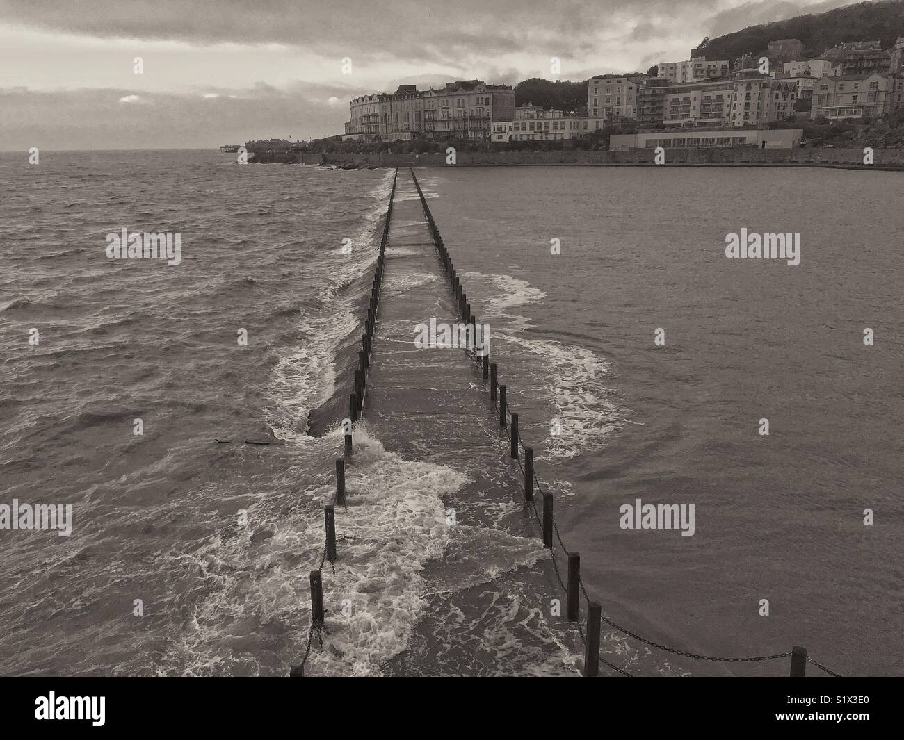Waves breaking over the Marine Lake causeway in Weston-super-Mare, UK - Smartphone Captured Stock Image
