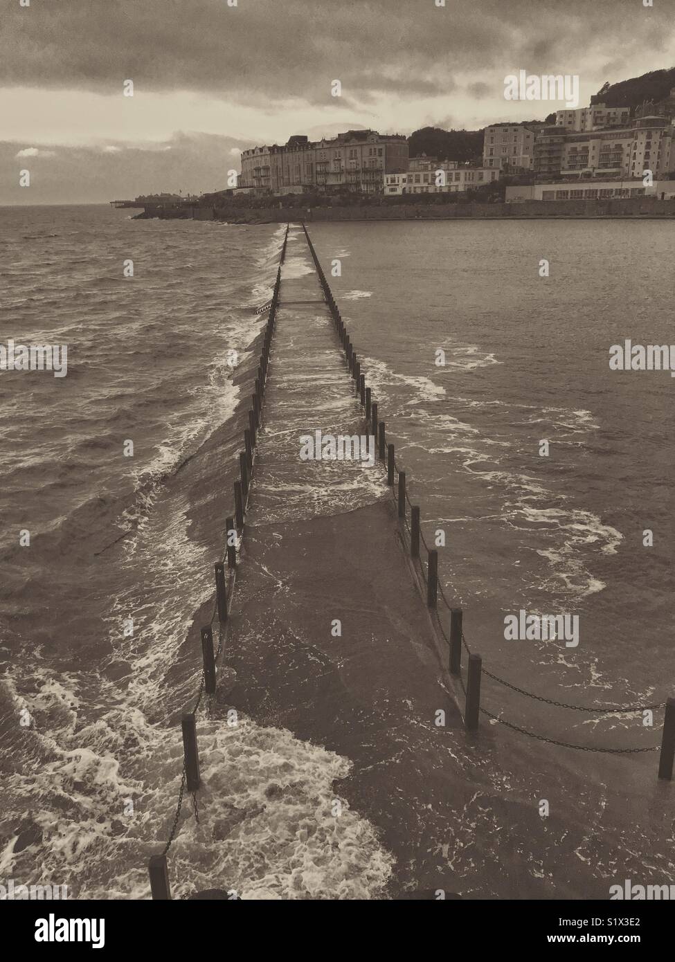 Waves breaking over the Marine Lake causeway in Weston-super-Mare, UK - Smartphone Captured Stock Image