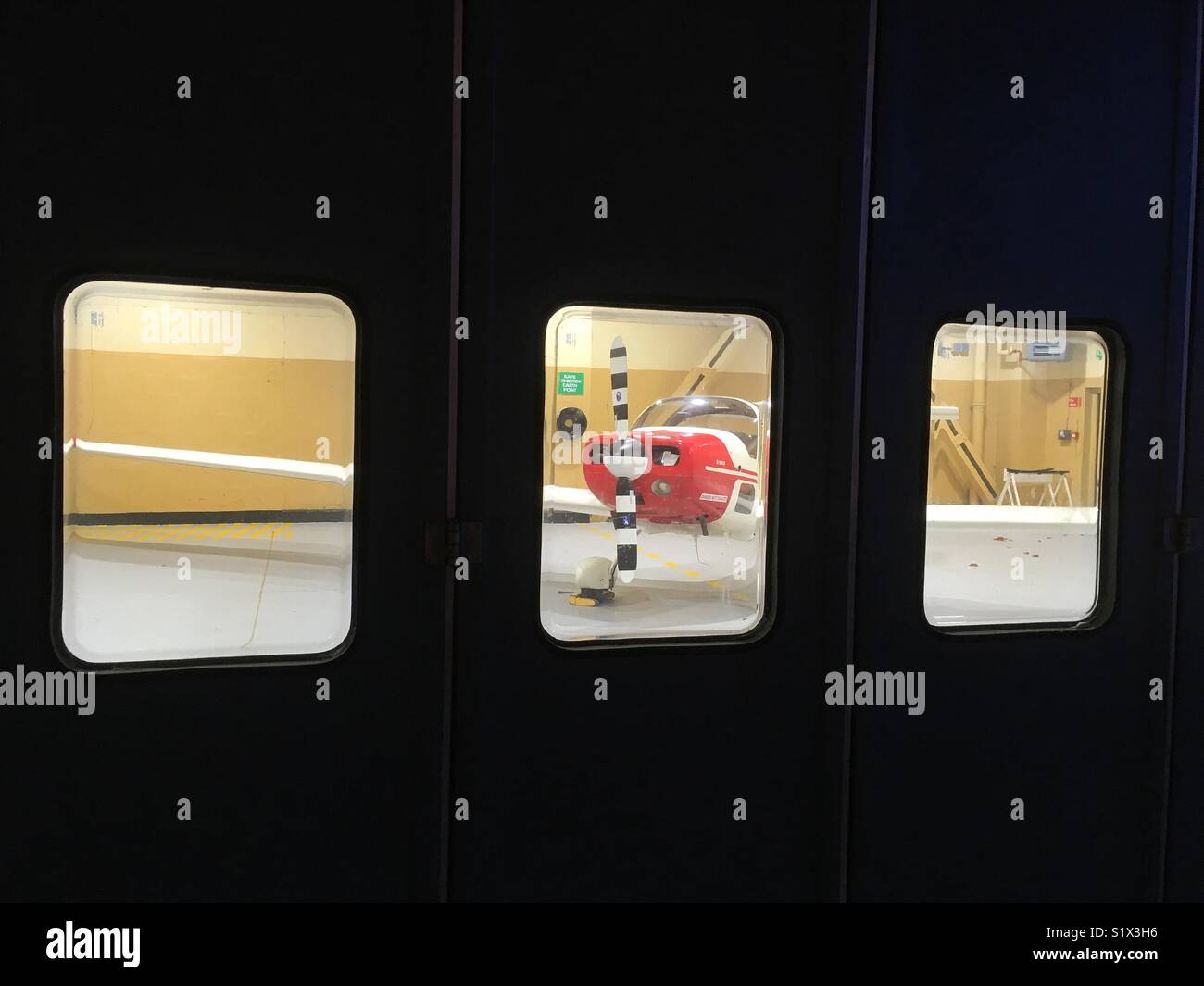 Aircraft seen through hangar windows - Smartphone Captured Stock Image