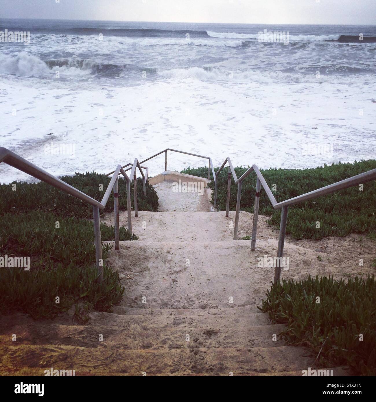 Steps down to the beach during a surf advisory, Santa Cruz, California - Smartphone Captured Stock Image