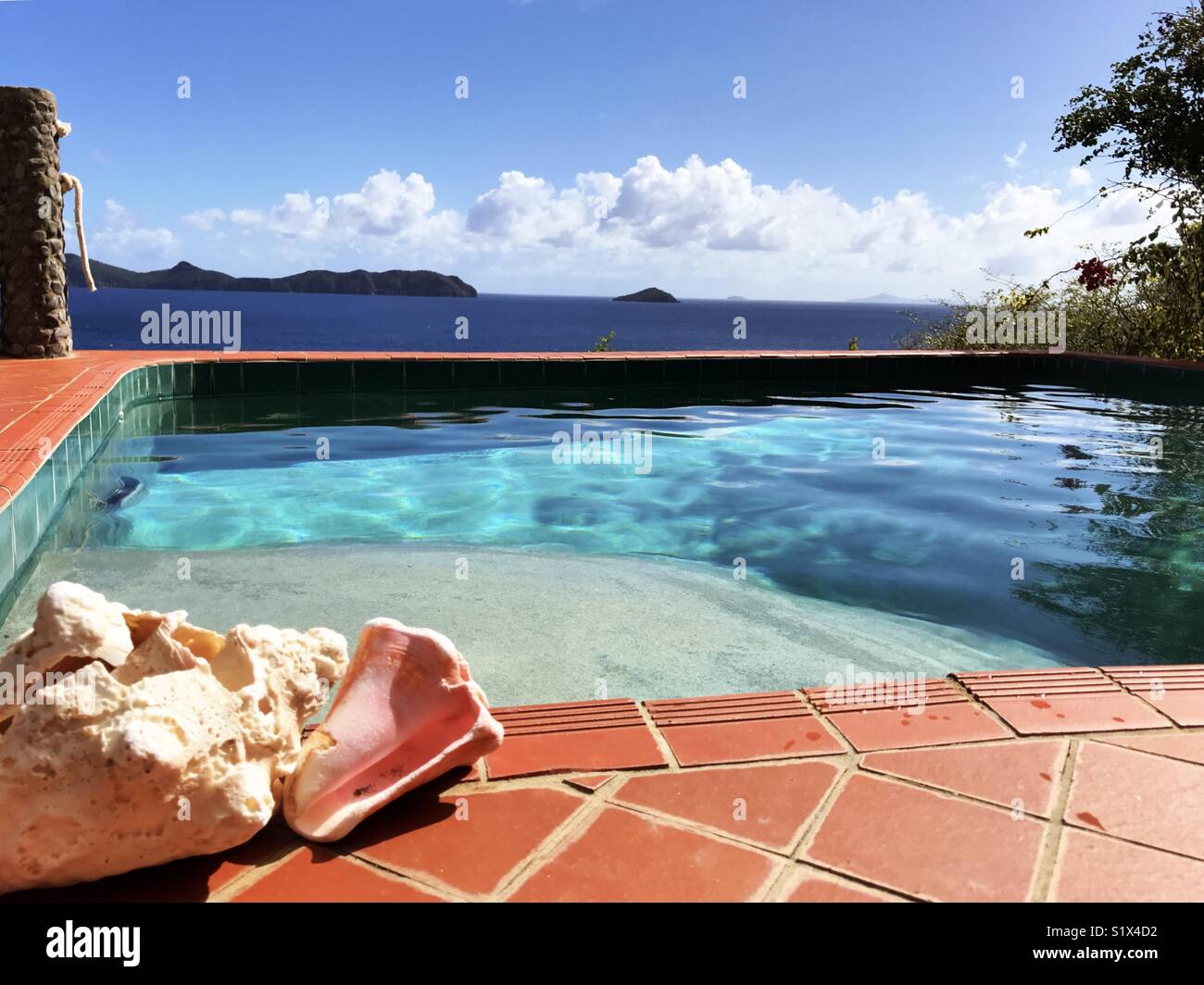 Pristine pool and ocean with island and conch shells Stock Photo - Alamy