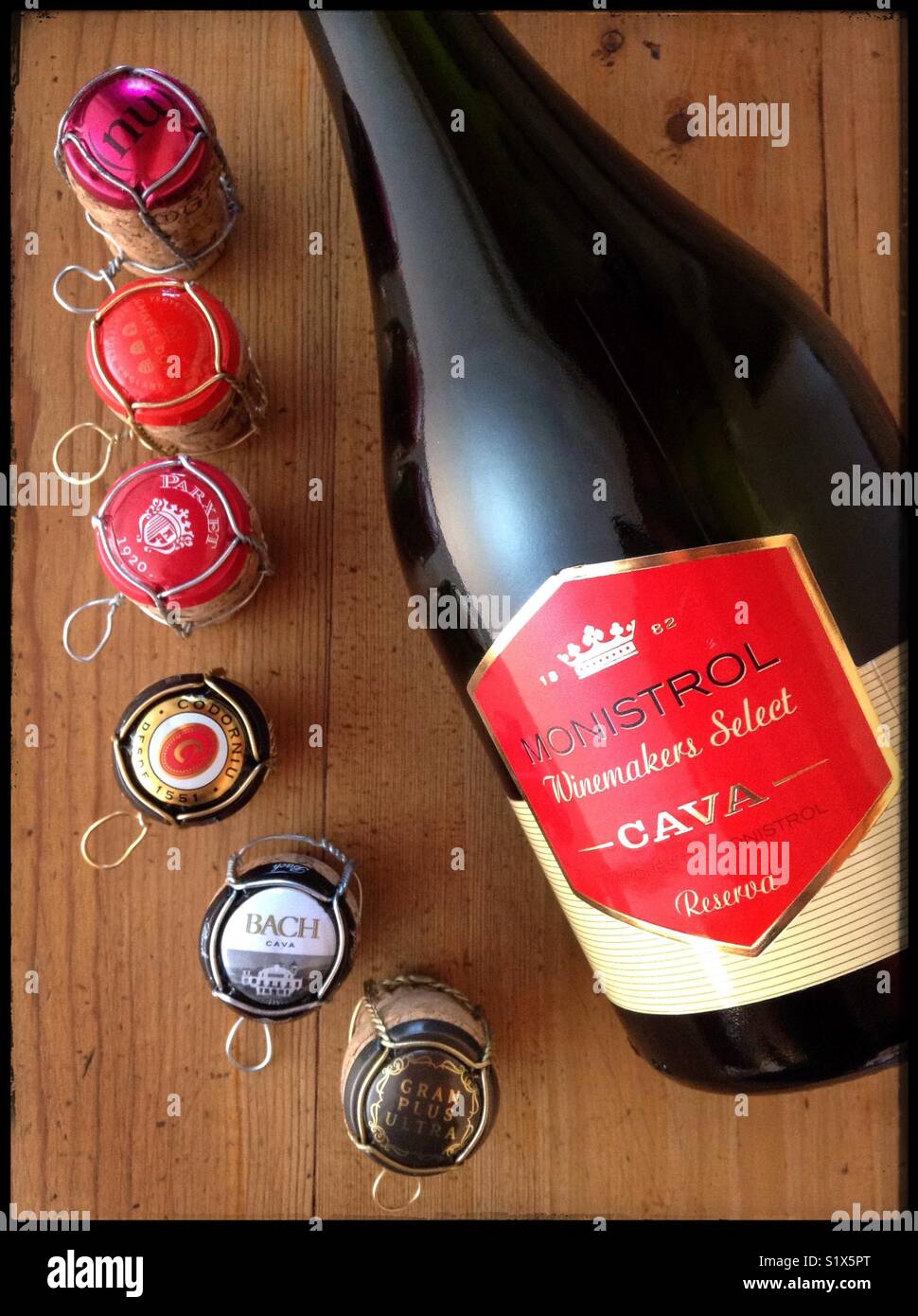 A collection of sparkling wine corks, cages and tops with a bottle of