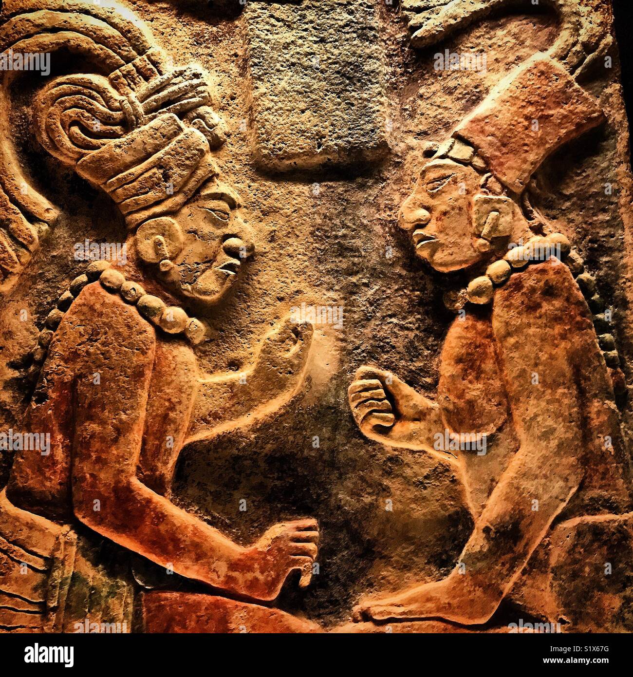 A sculpture of two Mayans sitting on a throne and speaking is displayed in Museo Amparo, Puebla de los Angeles, Mexico Stock Photo