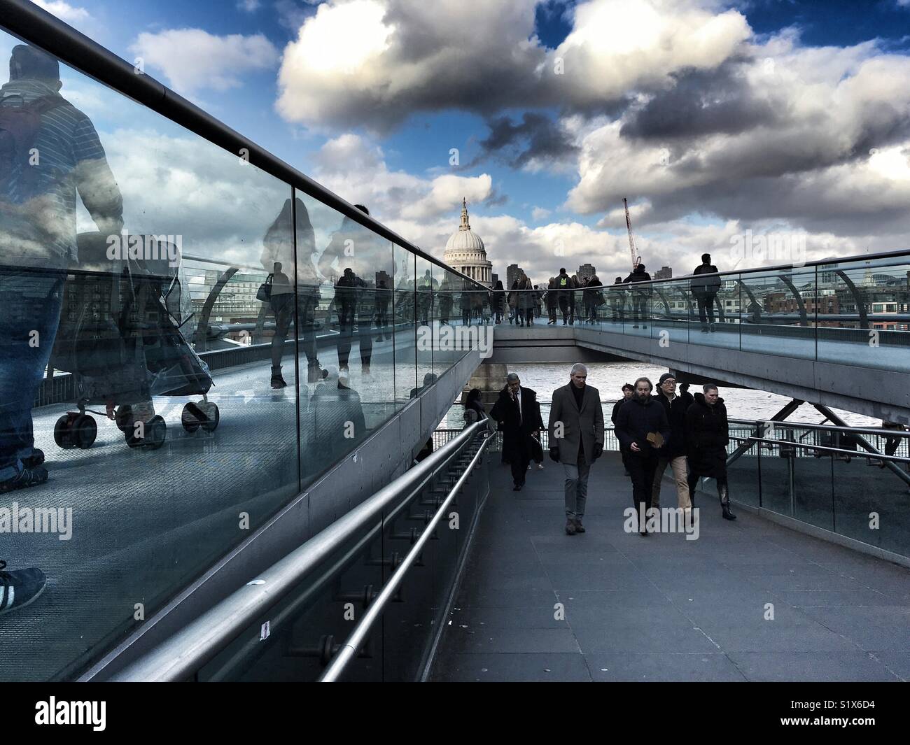 People walk across the Millennium bridge in London, England - Smartphone Captured Stock Image