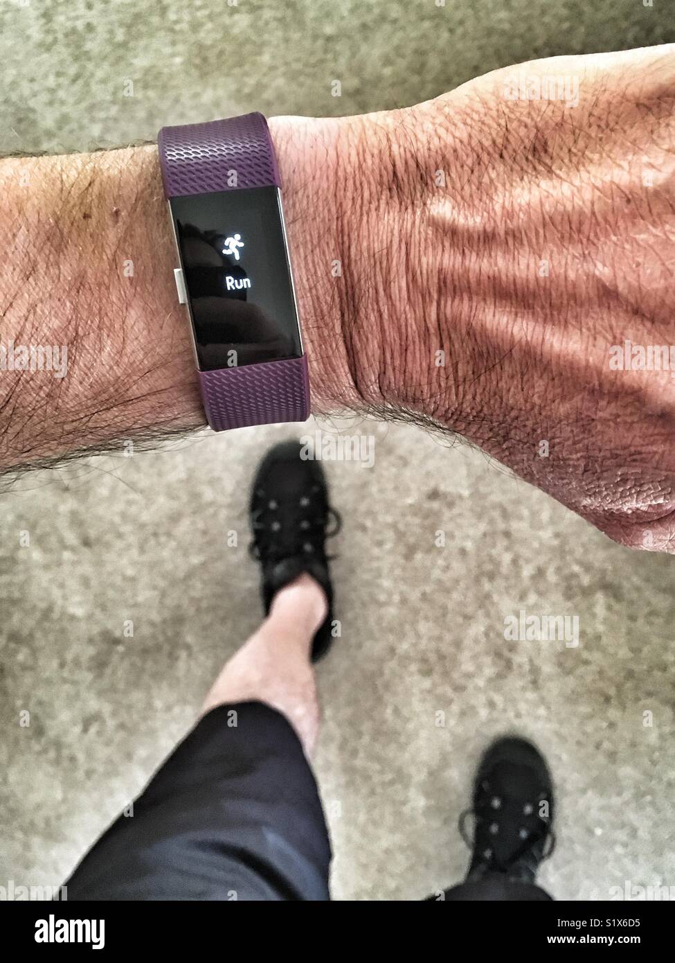 Man running with Fitbit Charge 2 set for a run Stock Photo