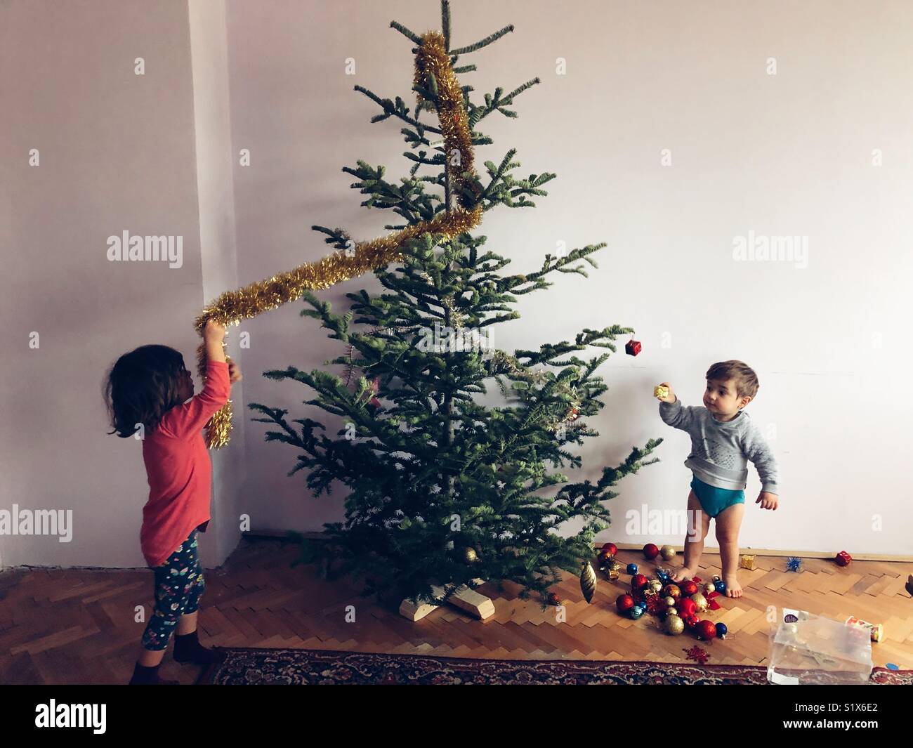 Childrens decorating a Christmas tree - Smartphone Captured Stock Image