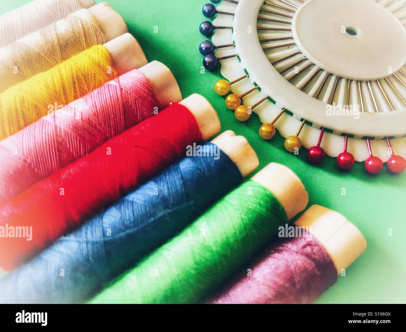 Sewing kit, colourful cotton thread and pins Stock Photo