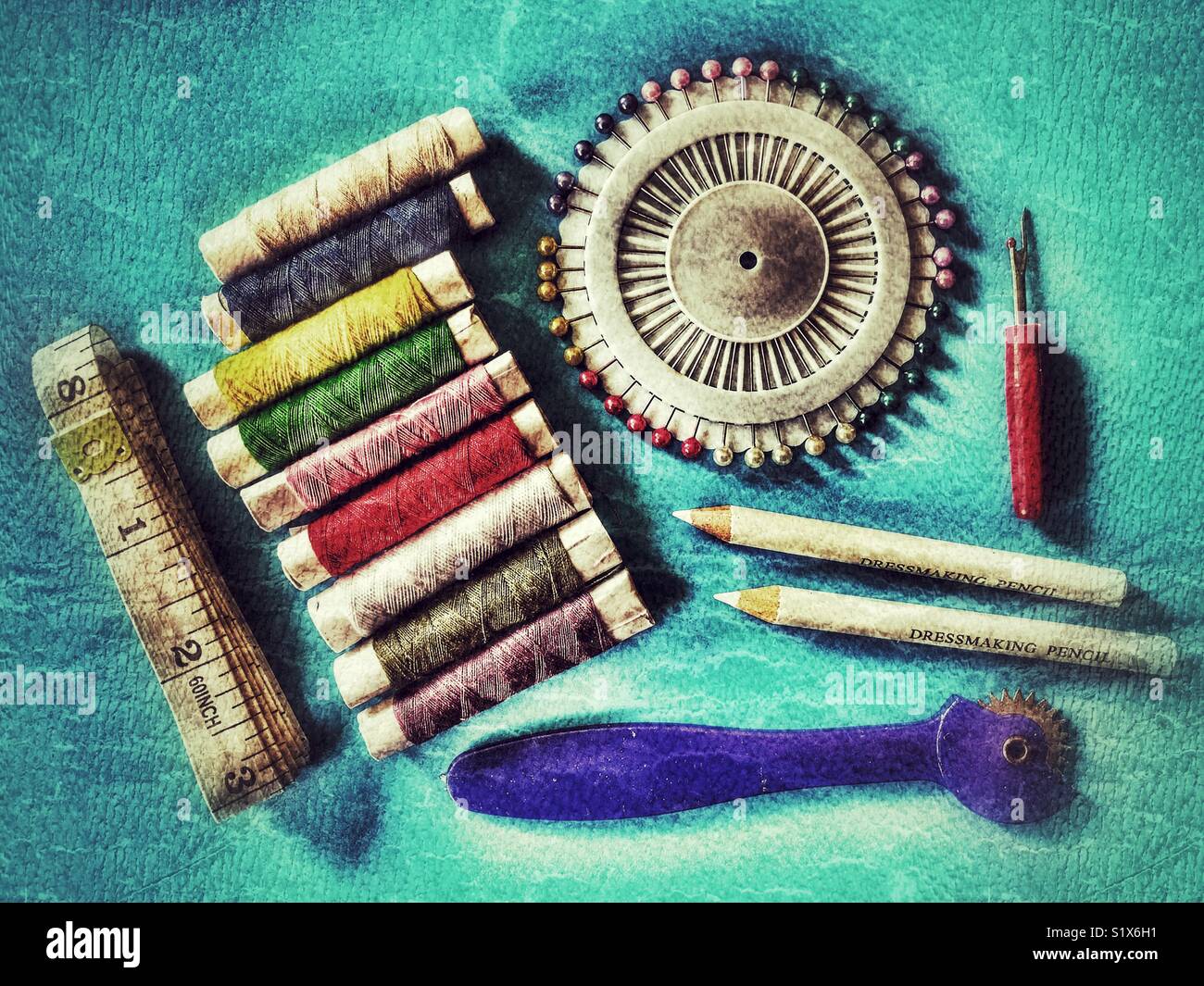 Sewing kit. Tape measure, colourful threads, pins, dressmaker pencils Stock Photo
