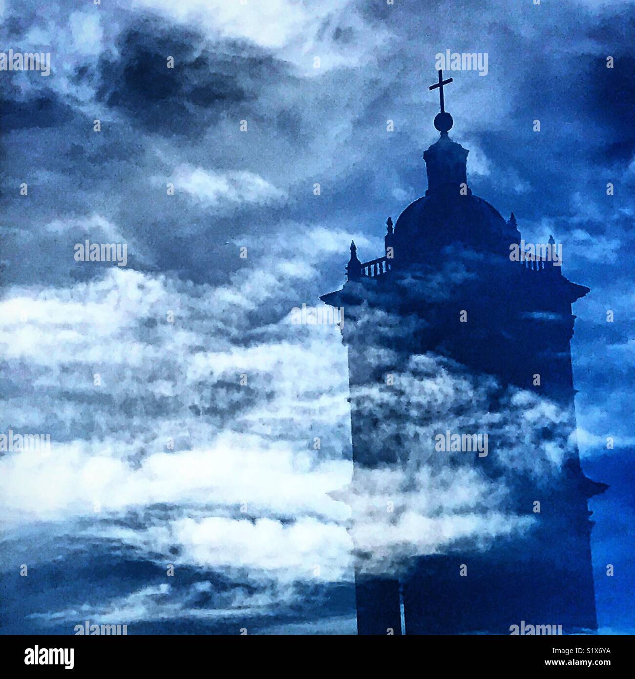 The reflection of a bell tower of the Catedral Metropolitana de Puebla in a window in Puebla de los Angeles, Mexico - Smartphone Captured Stock Image