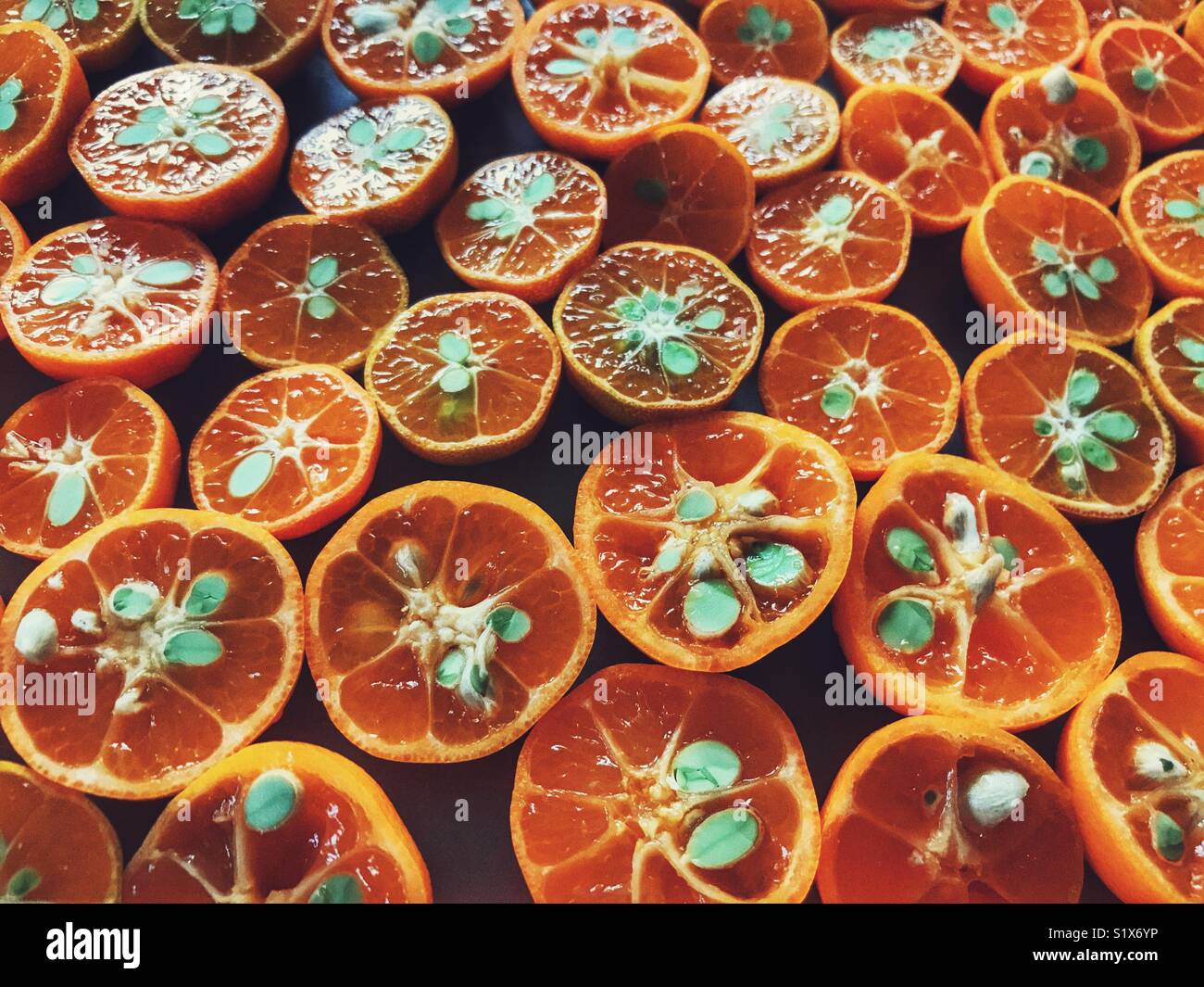 Limau kasturi limes, cut in half and laid out to dry prior to making pickle - Smartphone Captured Stock Image