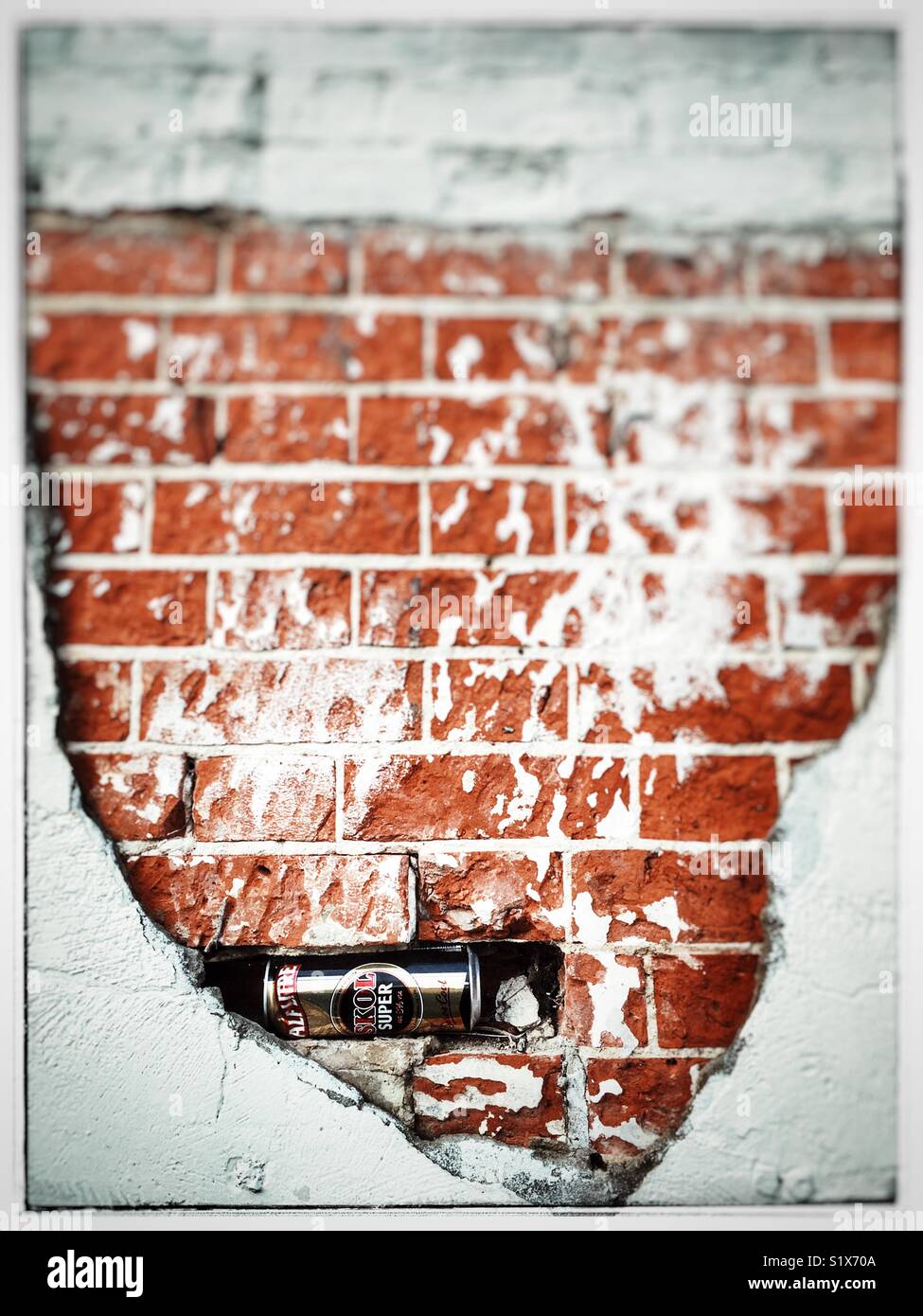 Skol Extra strong larger can stuck in a hole in a wall, Ipswich, Suffolk, UK. - Smartphone Captured Stock Image