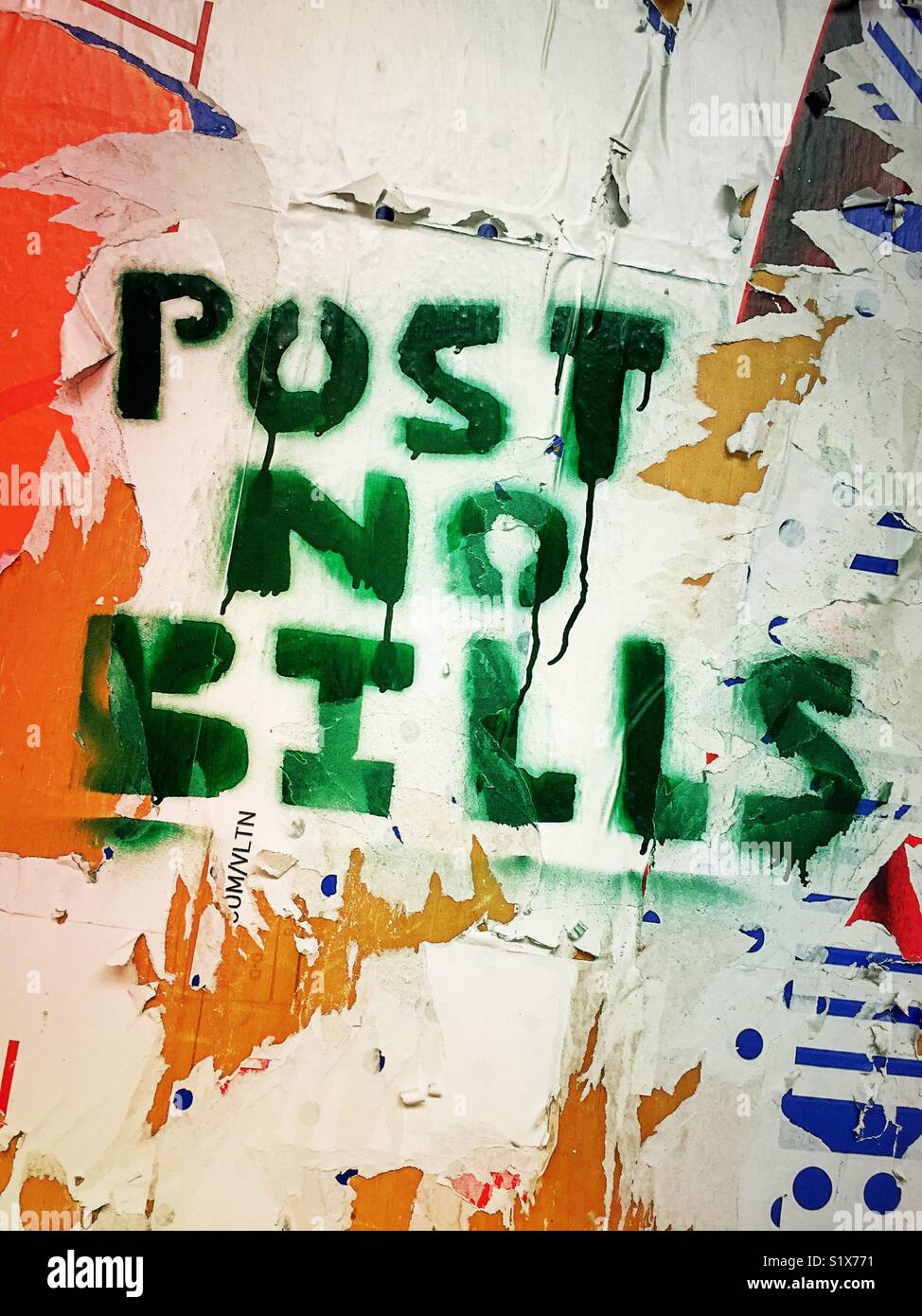 Post no bills sign painted over papered wooden wall, New York City, USA - Smartphone Captured Stock Image