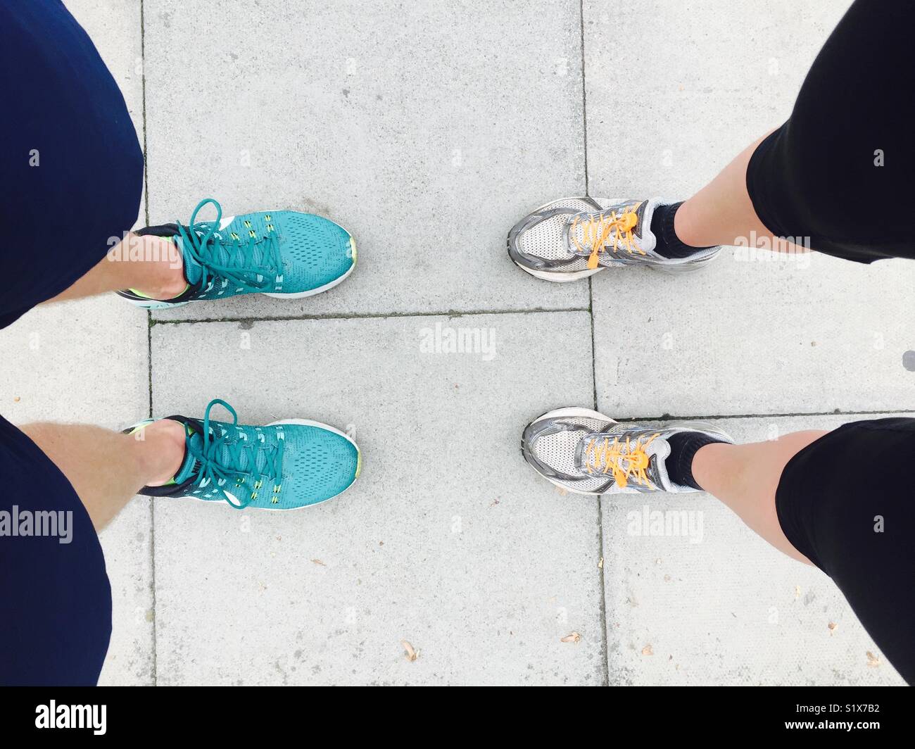 Looking down on two pairs of legs and feet - Smartphone Captured Stock Image