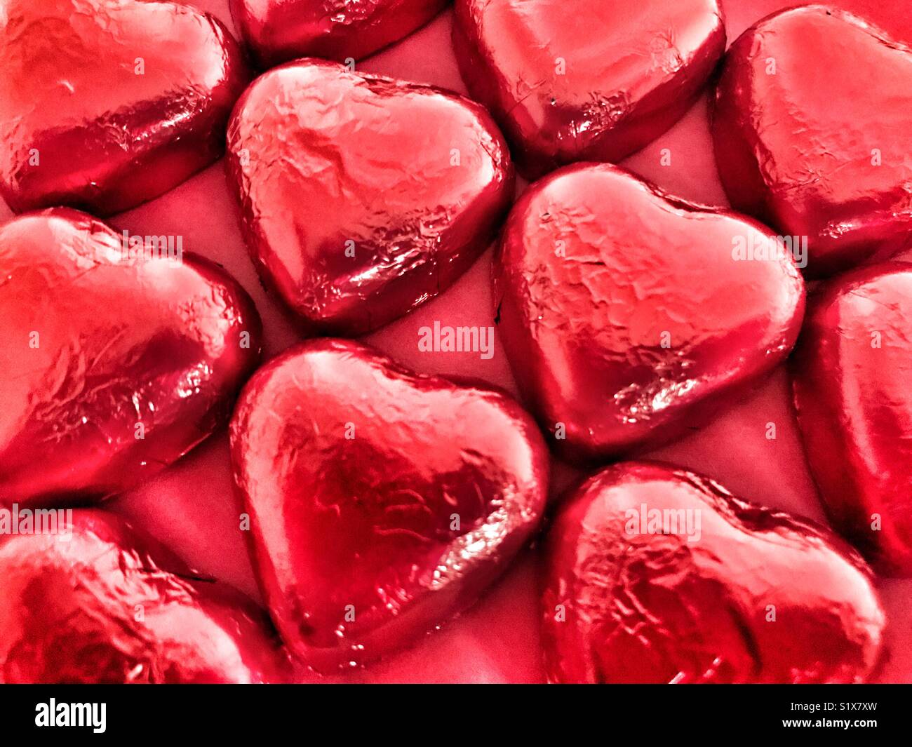 Valentine’s Day, heart shaped chocolates wrapped in red foil - Smartphone Captured Stock Image