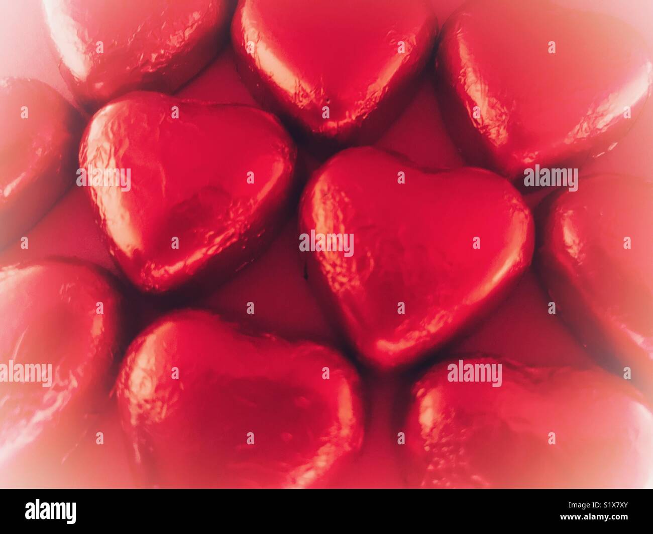 Valentine’s Day, heart shaped chocolates wrapped in red foil - Smartphone Captured Stock Image