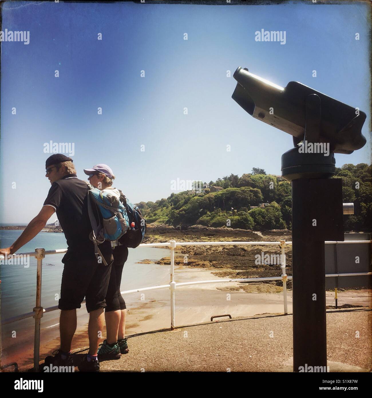 Two people looking out to sea at Rozel Bay, Jersey, Channel Islands, United Kingdom - Smartphone Captured Stock Image
