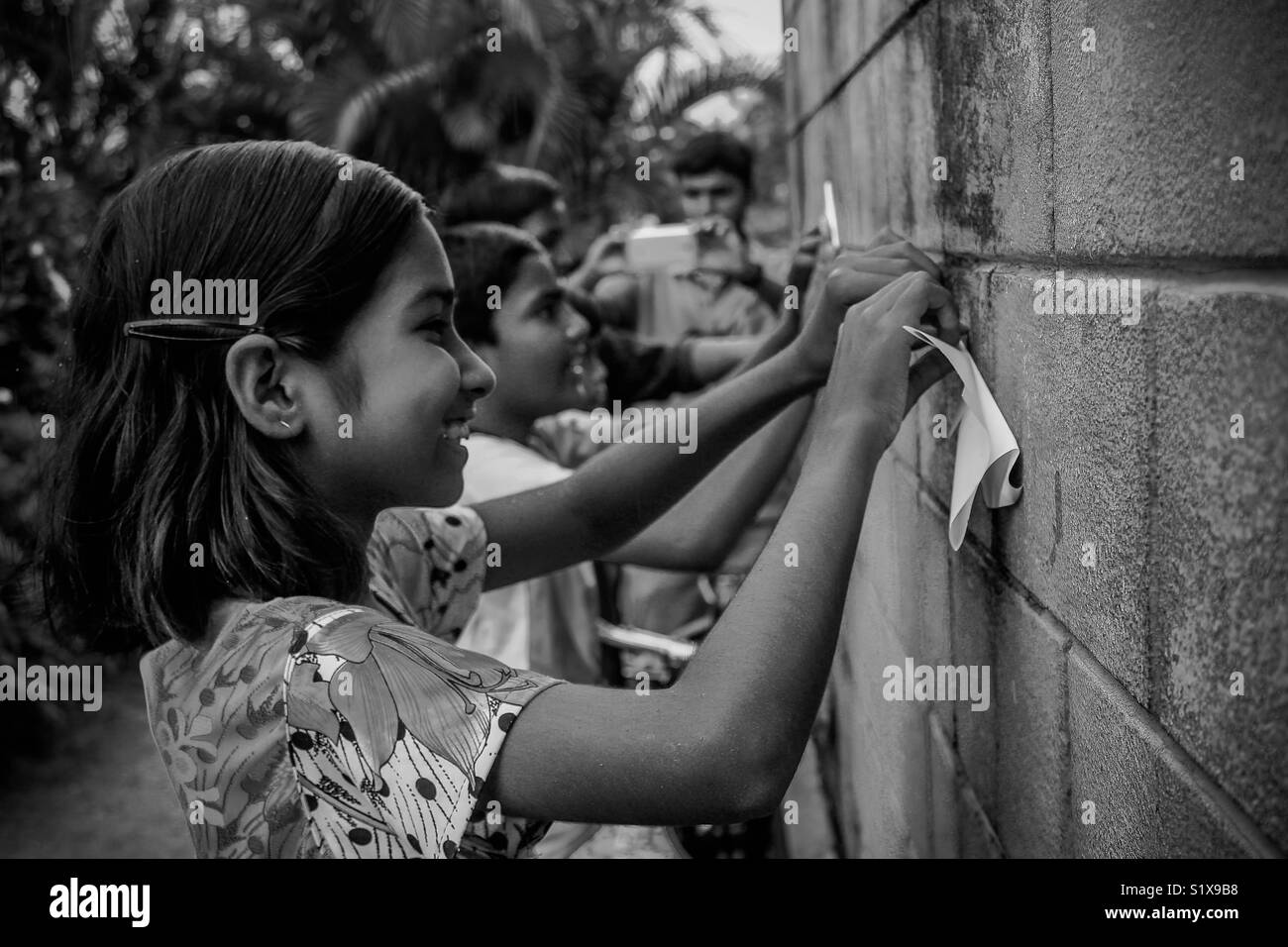 A girl smiling and making paper planes stock photo alamy