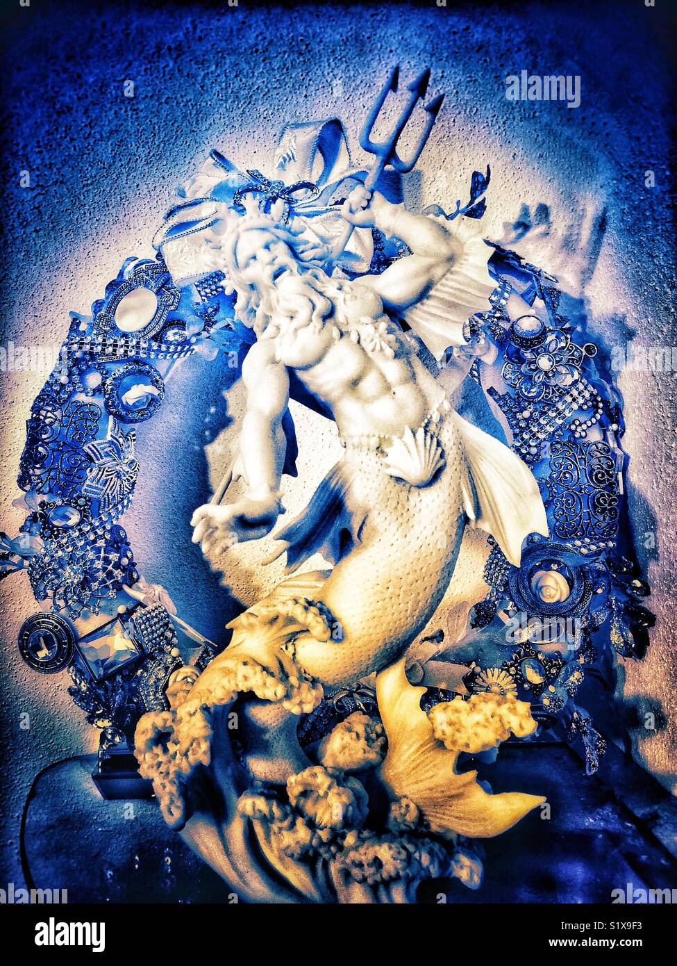 Poseidon statue with eclectic wreath in background - Smartphone Captured Stock Image