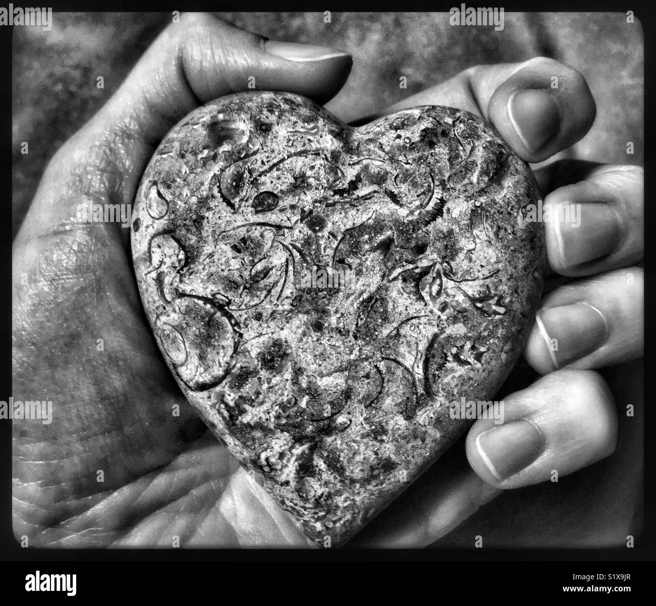 Stone heart in hand Stock Photo Alamy
