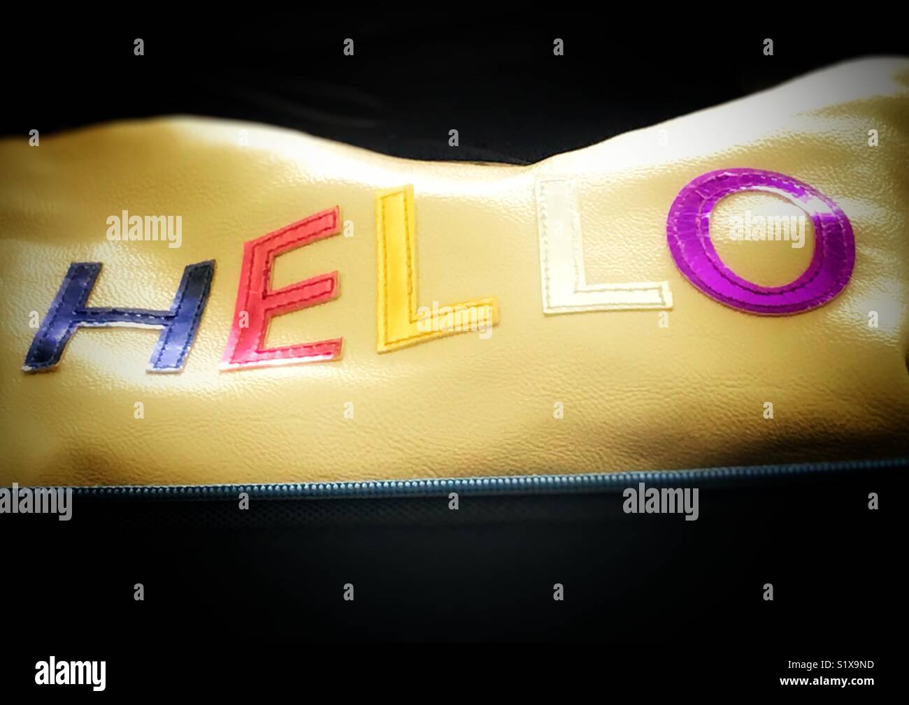 Hello, lettering in block capitals, and different colours against a light yellow background. Stock Photo