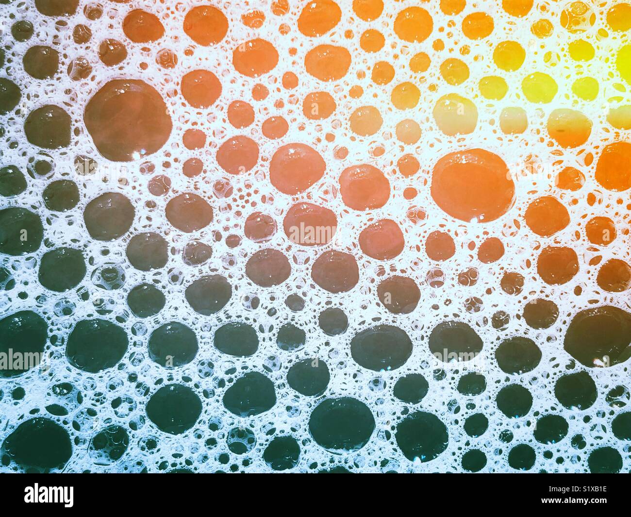Closeup of bubble bath bubbles with rainbow light effect - Smartphone Captured Stock Image