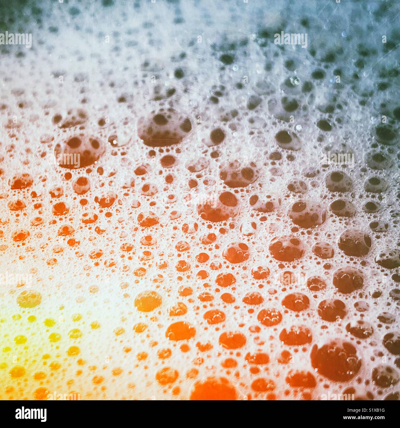 Closeup of bubble bath bubbles with rainbow light effect - Smartphone Captured Stock Image