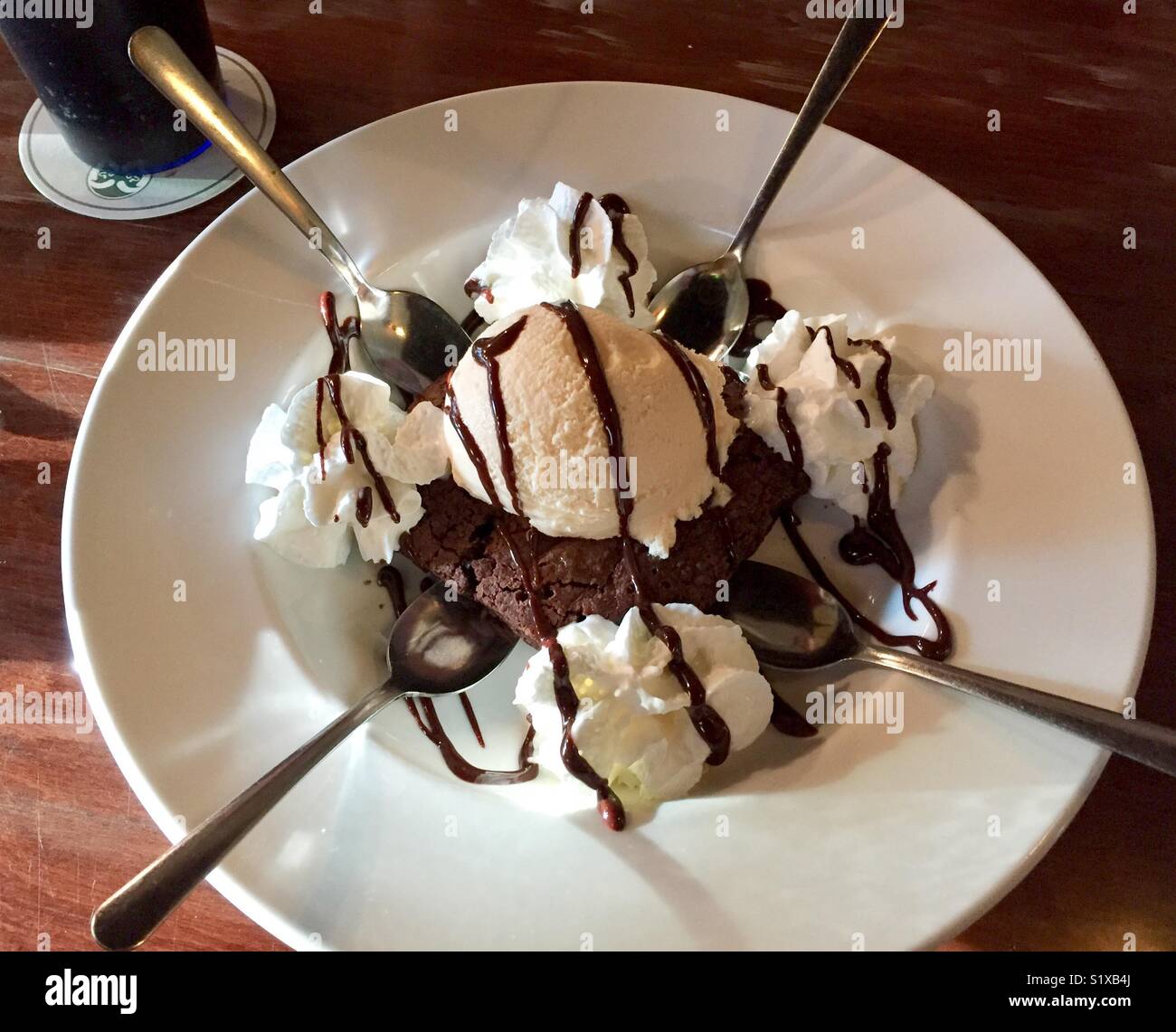 Fudge brownie sundae dessert with four spoons Stock Photo Alamy