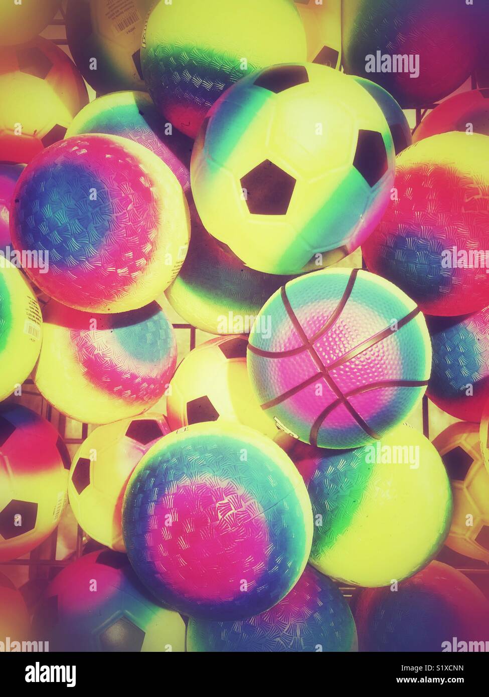 Bin full of multicoloured rubber sports balls - Smartphone Captured Stock Image