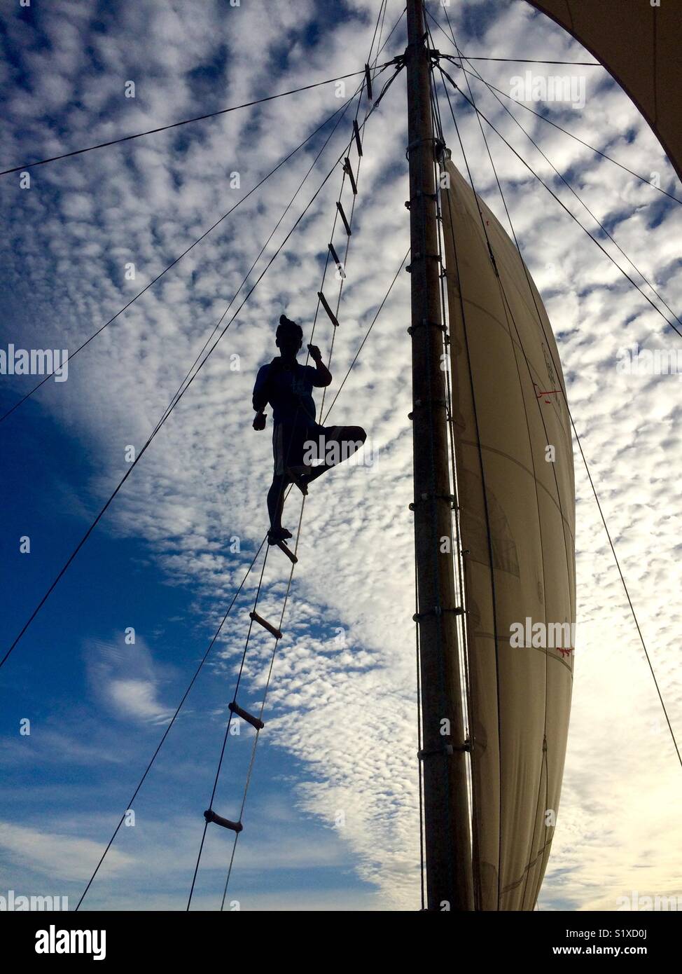 Sailor climbing up the mast on a traditional Philippine boat Stock Photo