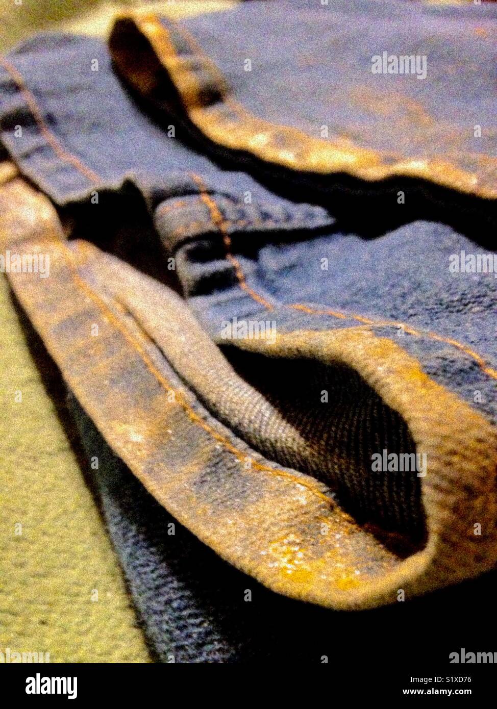 Gold edged hem from walking through mud - Smartphone Captured Stock Image