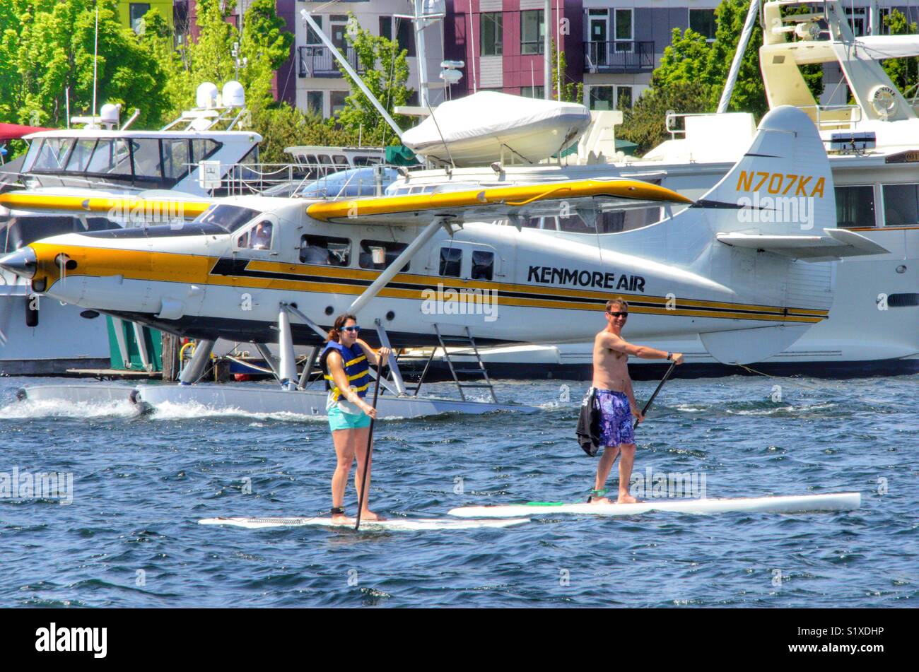 Man and a woman on paddle boards in Lake Union, Seattle Washington - Smartphone Captured Stock Image