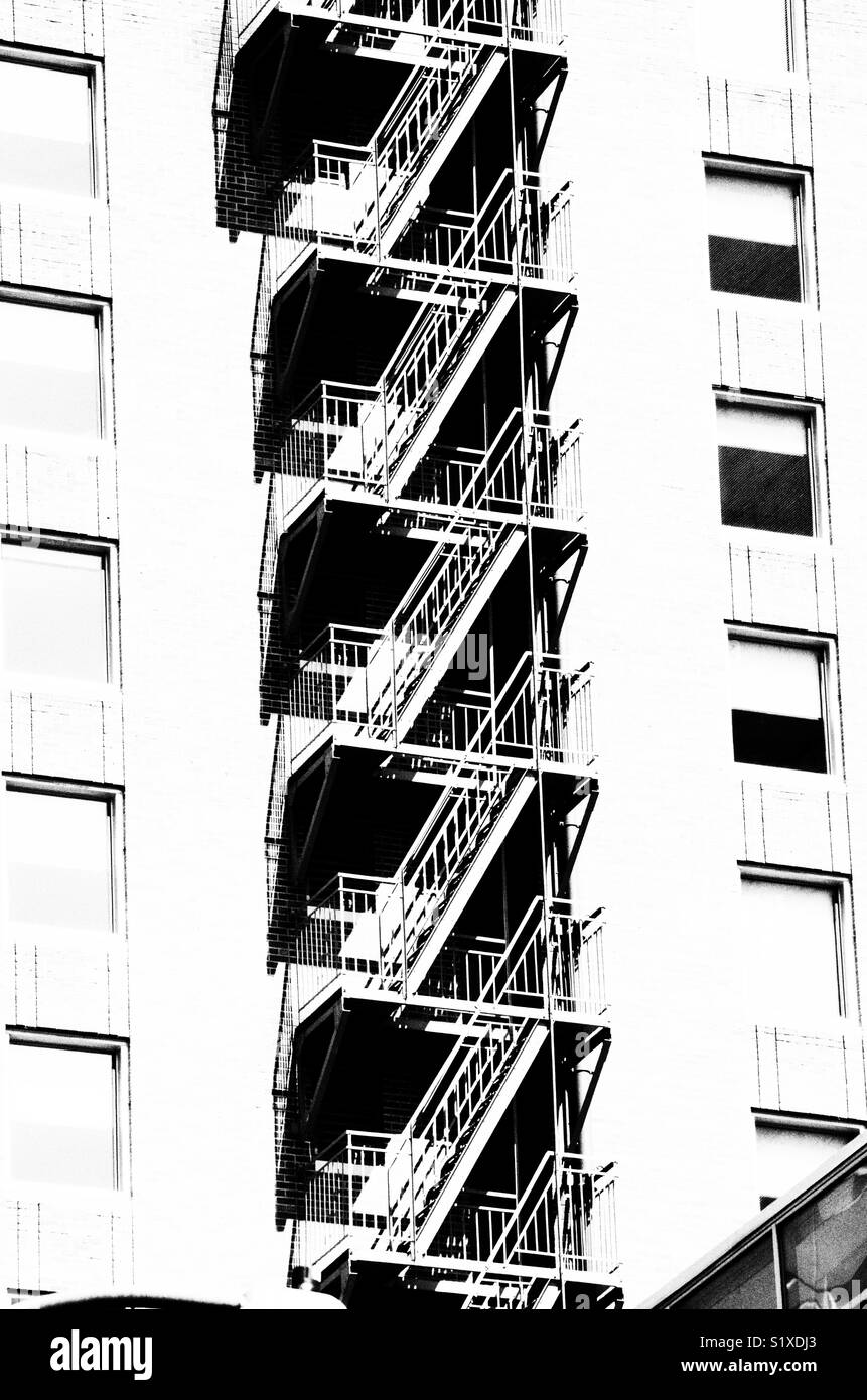 Graphic picture of fire escape on the side of a building in Seattle Washington. Black and white Stock Photo