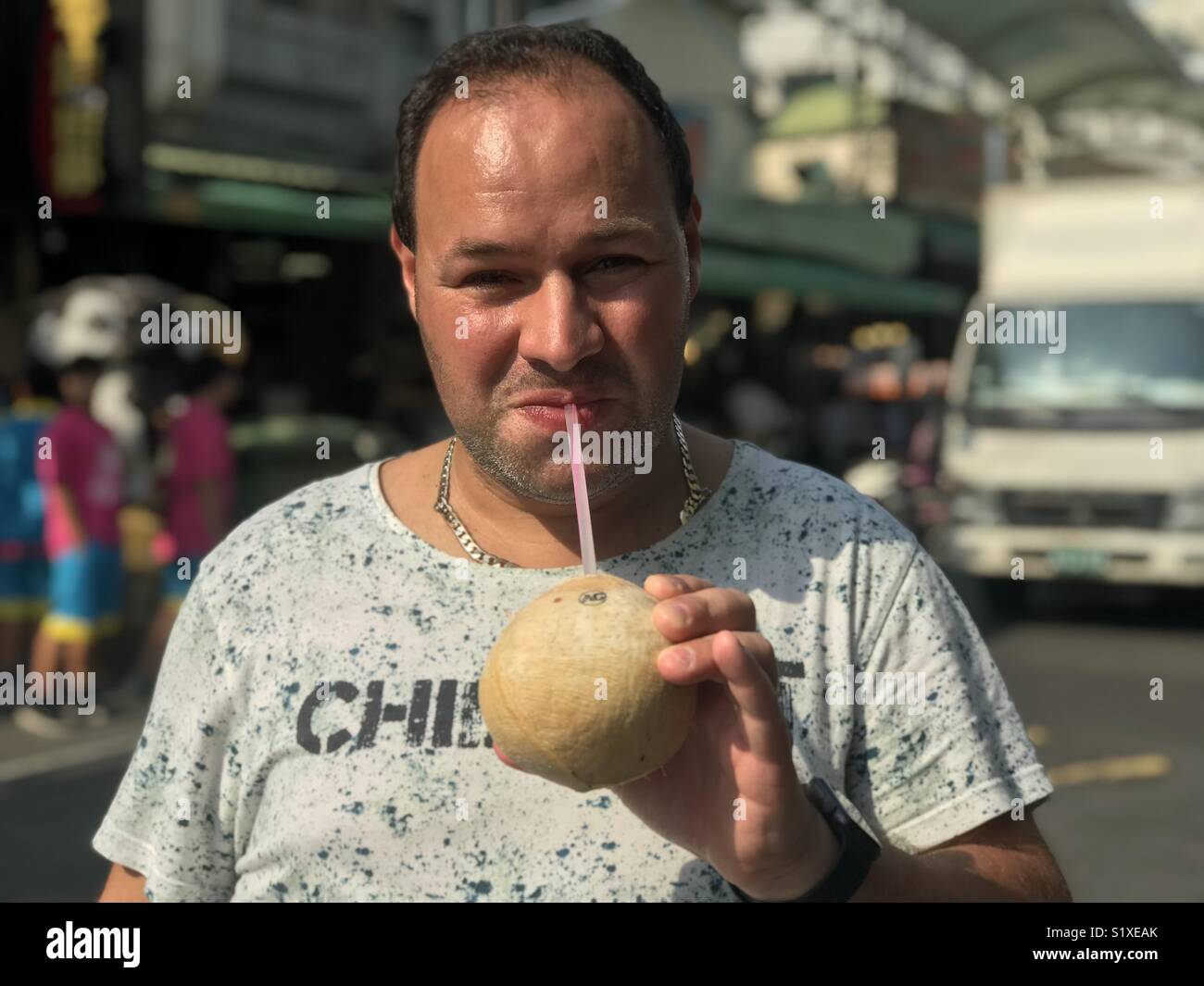 Man drinking coconut water - Smartphone Captured Stock Image