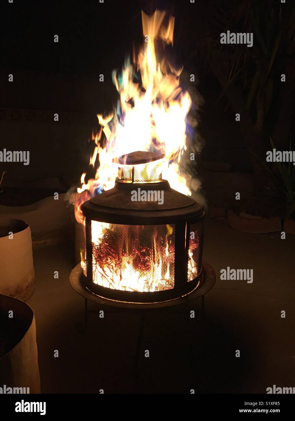 Flames Shoot Out Top Of Backyard Firepit Stock Photo 310984021