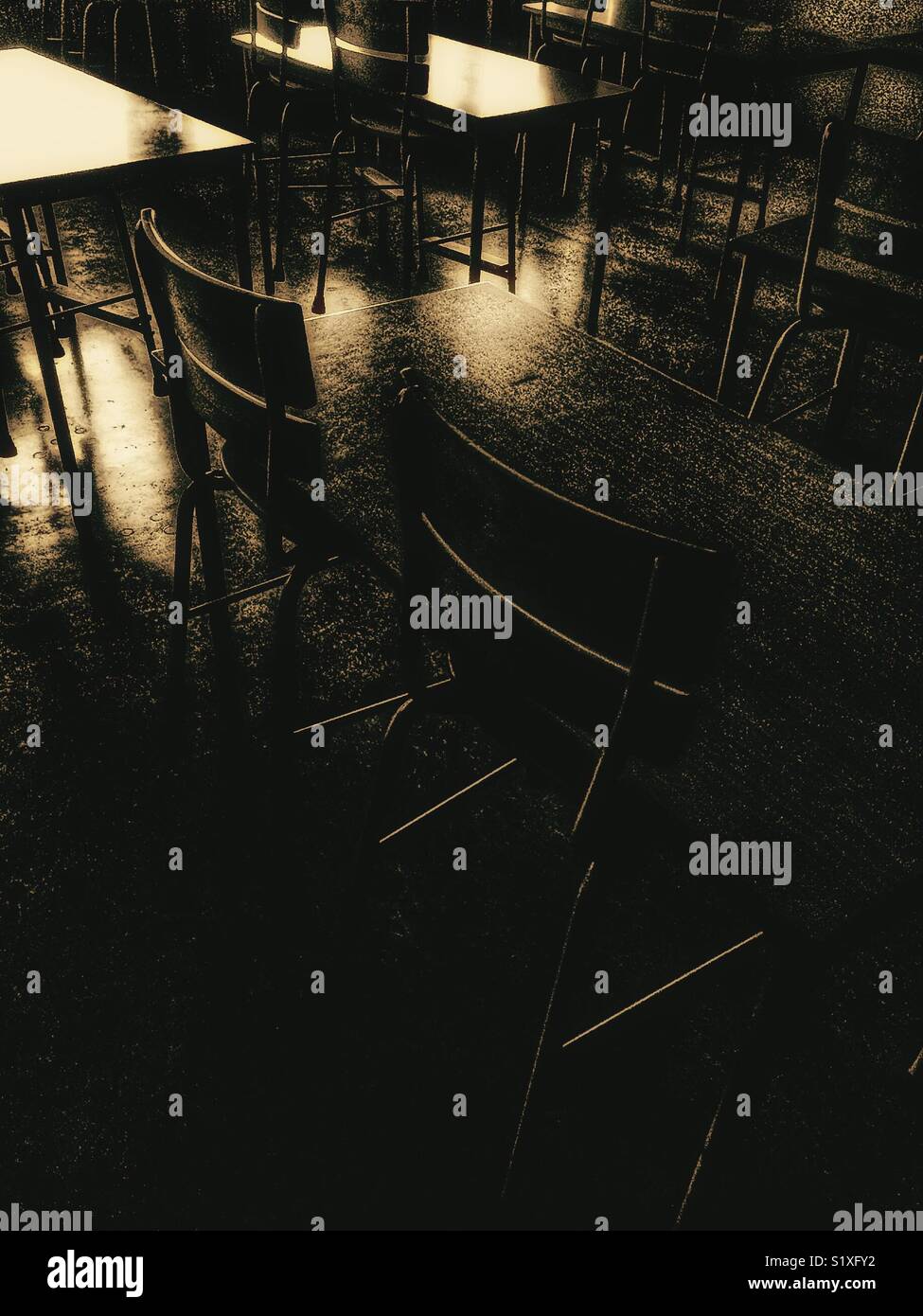 Atmospheric empty classroom with tables and chairs - Smartphone Captured Stock Image