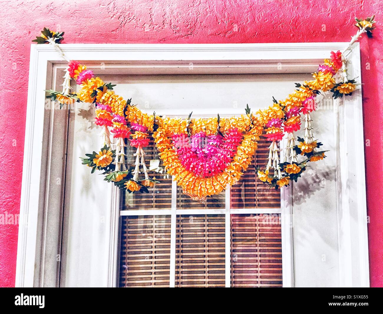 Flower garland over door of Asian restaurant Stock Photo Alamy
