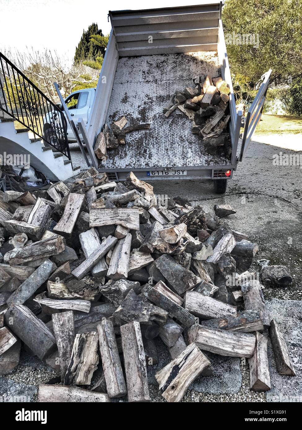 Van with tipper trailer delivering firewood - Smartphone Captured Stock Image