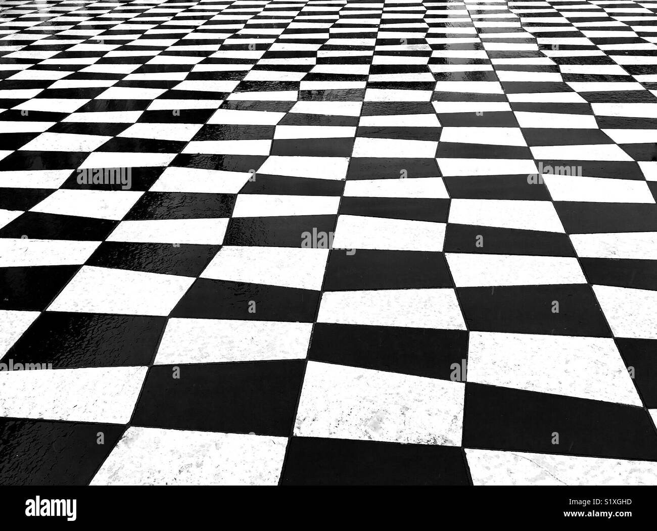Pattern formed by black and white paving stones in a public square in Nice, France - Smartphone Captured Stock Image