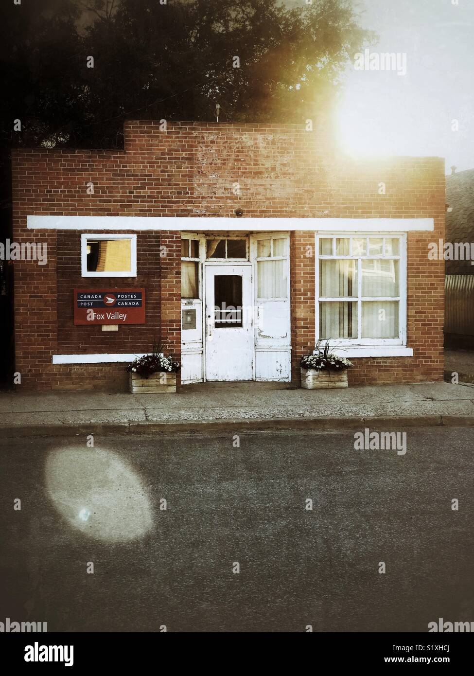 The early-1900s building that houses the post office in the small Canadian prairie village of Fox Valley. - Smartphone Captured Stock Image