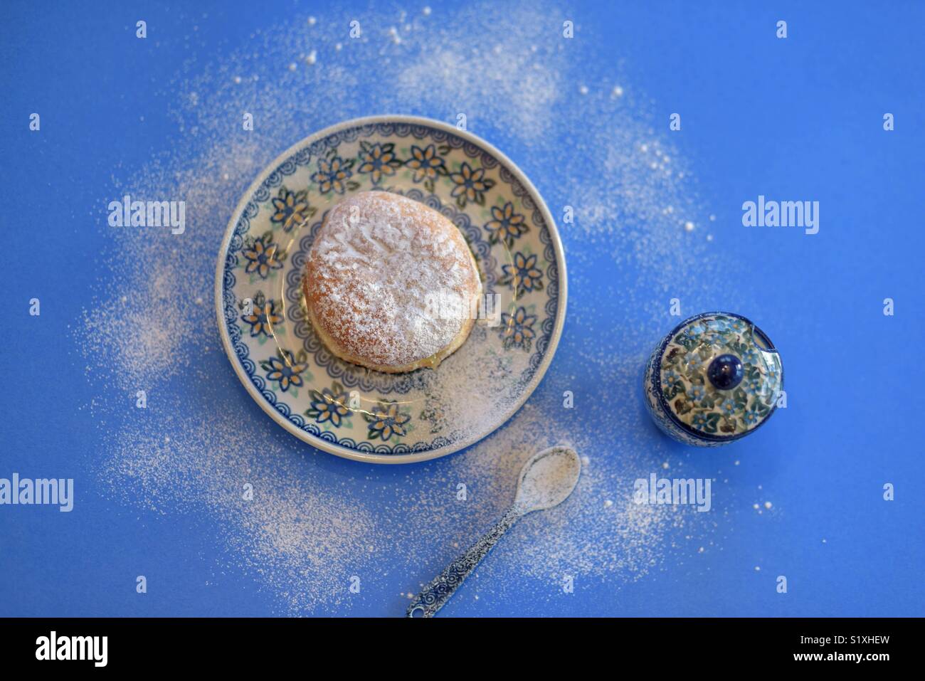 Overhead food shot of traditional Polish Paczki on Polish pottery plate with blue background Stock Photo