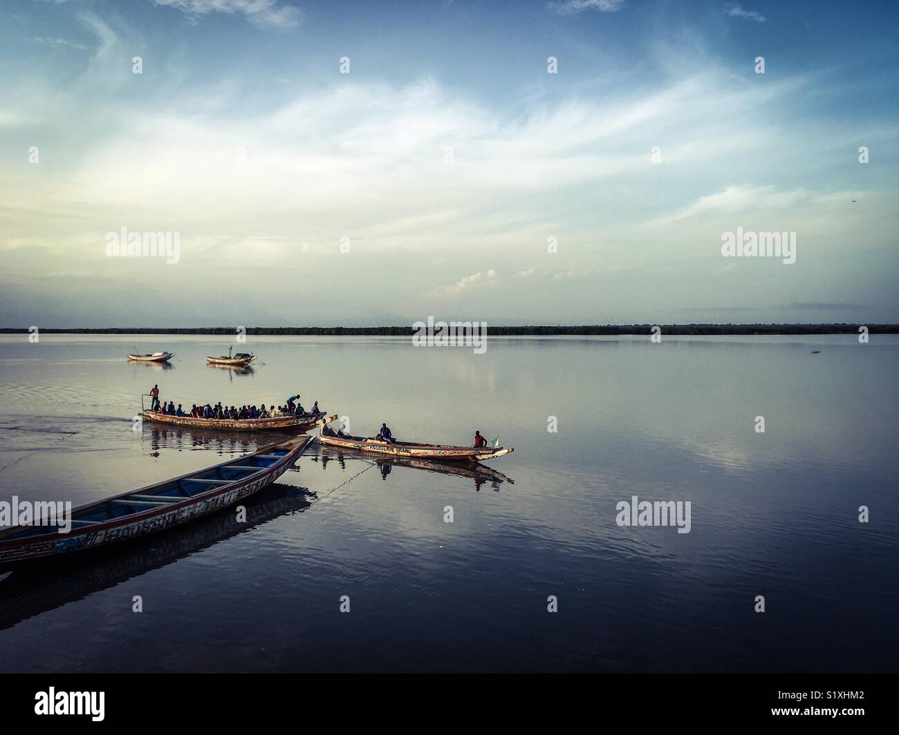 Local Pirogues Ferry Passengers Across The Casamance River Stock Photo Alamy
