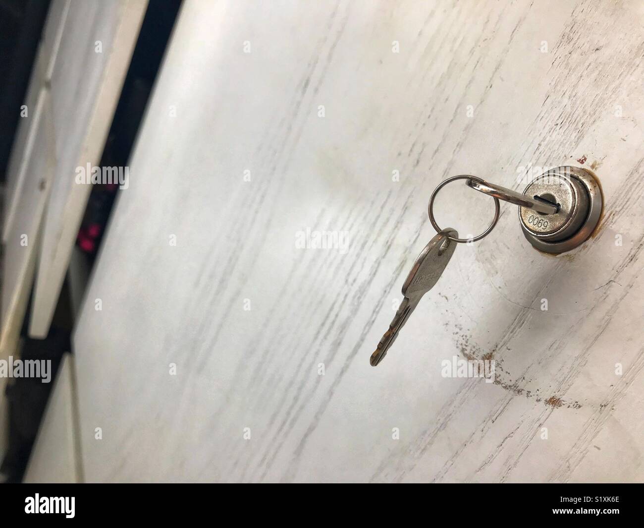 Key in lock in cupboard. Some are not locked Stock Photo