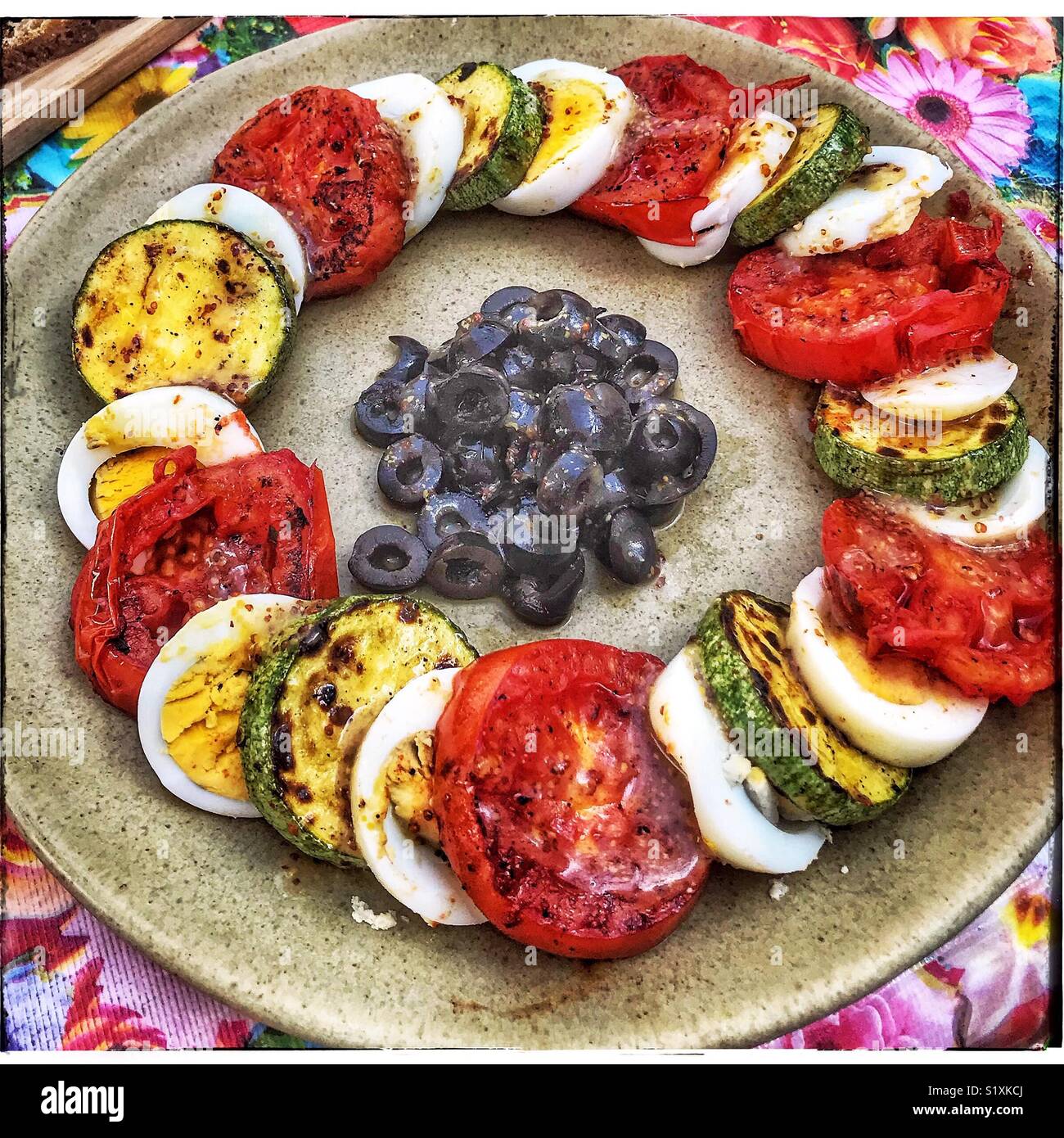 A healthy and beautiful breakfast featuring sliced hard boiled eggs, roasted squash and tomatoes surrounding olives is a specialty at LA133 in San Antonio Tlayacapan near Ajijic, Mexico. Stock Photo