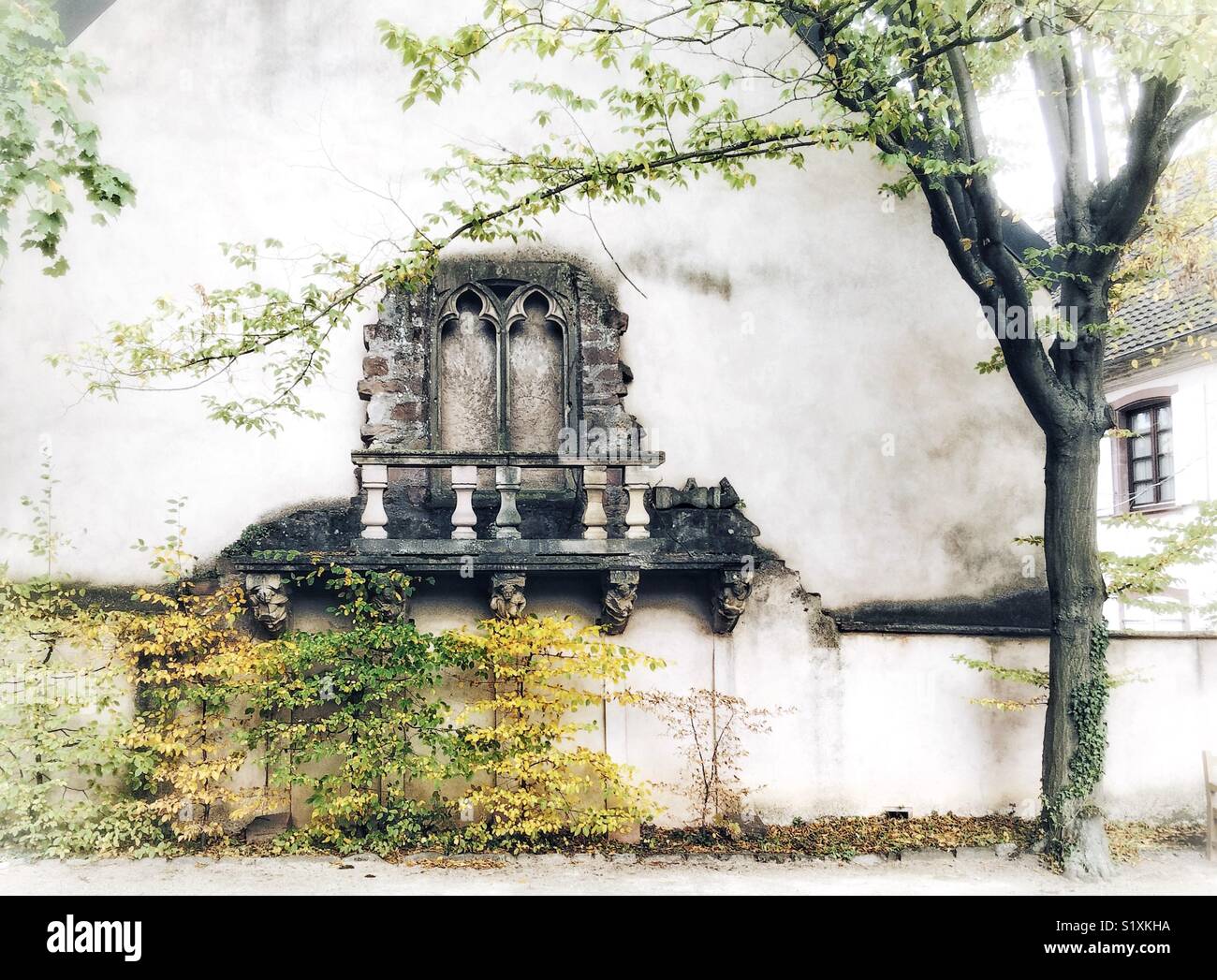 A balcony made of stone in a garden in France. - Smartphone Captured Stock Image